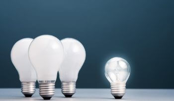 Small light bulb has own light and more brighter than the group of big ones, business concept,